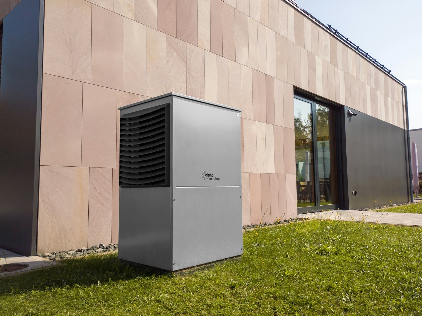 Air source heat pump unit installed beside a modern property